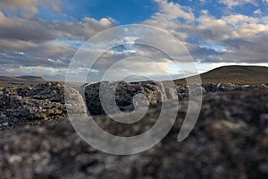 A low view detail of Limestone Pavement with penyghent and ingleborough in the background