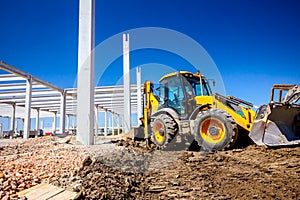 Low view on front excavator`s work tool, blade