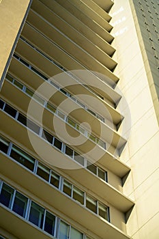 Low view of hotel or residential and commercial real estate building with decorative facade walkways and interior walls