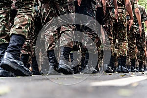 Low view of the legs of Brazilian army soldiers marching through the streets of Salvador, Bahia, during the commemoration of