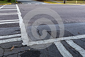 Low view of street intersection with crosswalks marked in layers of heavy paint, crossroads with creative copy space
