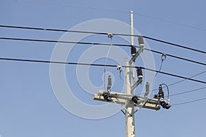 Low voltage power transmission towers and equipment on clean sky background