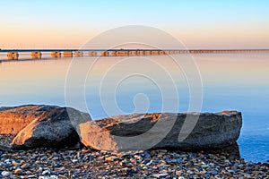 Low water bridge from Sedanka to the De Friz peninsula across the Amur Bay of Primorsky Krai Russia against the background of a