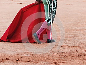 Legs, muleta and sword of a matador photo