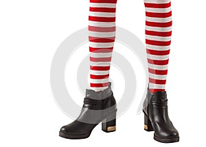 Lower half of girl wearing stripey socks and boots photo