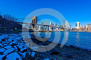 Lower Manhattan Downtown skyline panorama from Brooklyn Bridge Park riverbank, New York City, USA