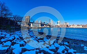 Lower Manhattan Downtown skyline panorama from Brooklyn Bridge Park riverbank, New York City, USA