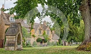 Lower Slaughter with old 18th Century drinking fountain, The Cotswolds, England