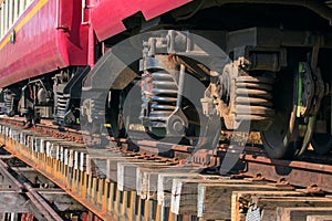 Lower view of trainst suspension on old wood railways bridge