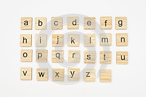 Lowercase alphabet letters on scrabble wooden blocks photo