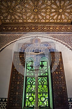 Lowlight window with arches and column with wall and ceiling with Islamic decoration, Seville SPAIN