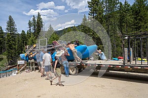 Lowman, Idaho - July 1, 2019: Whitewater Rafting groups prepare to launch a raft for a river rafting trip down the ramp for a trip