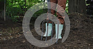 Lowsection of african american boy holding garden fork in garden