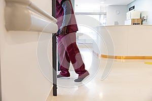 Lowsection of african american male doctor walking in hospital corridor