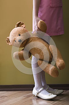Lowsection Of Girl Holding Teddy Bear photo