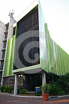 Lowy Cancer Research Centre with green metal panels and vertical slat screening on exterior facade at UNSW, Sydney, Australia