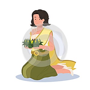 Loy Krathong Traditional Festival. woman in Thai traditional dress is sitting and hold kratong and prepare to bring Krathong to