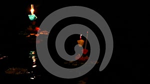 Loy Kratong Festival reflection light on the water surface, Some evidence is believed to be the worship of the Buddha`s footprint