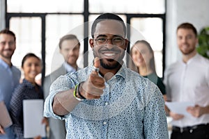 Loyal black male client demonstrating thumb up recommending good service photo