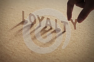 LOYALTY wood word on compressed board