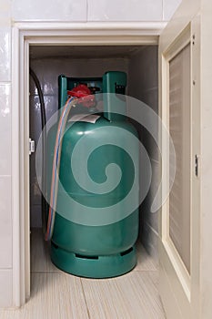 The LPG gas tank for cooking is stored in the small storage compartment