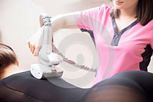 LPG machine massage for lifting body. Woman getting beauty therapy against cellulite in spa salon