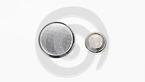 LR44 and CR2032 button cell batteries on a white background. Close up.