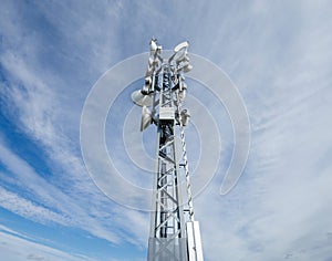 LTE, 6G, and WiFi tower against cloudy sky photo