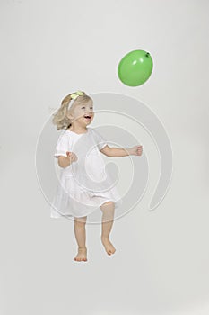 Ltiitle girl playing with a balloon