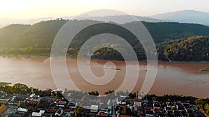 Luang Prabang, Laos. Aerial view Luang Prabang town in Laos. Cloudy sky over small city surrounded by mountains. Mekong