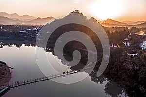 Luang Prabang, Laos. Aerial view Luang Prabang town in Laos. Cloudy sky over small city surrounded by mountains. Mekong river