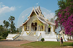 Tourist takes photo of the Haw Pha Bang Buddhist temple at the Royal Palace Museum in Luang Prabang, Laos.