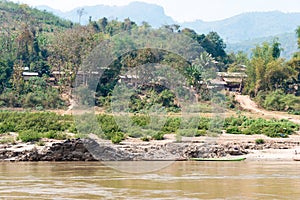 Luang Prabang, Laos - Mar 04 2015: Slow boat cruise on the Mekong River. Popular tourist adventure trip by slow boat from