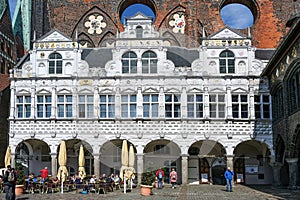 Lubeck, Germany, April 17, 2023: Renaissance facade of the historic Luebeck town hall in front of other historic parts in brick