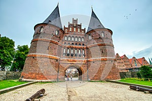 Lubeck, Germany - July 22, 2016: Tourists visit famous Holstentor gate in summer, Schleswig-Holstein, northern Germany