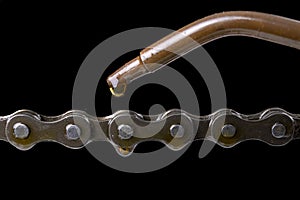 Lubricate the bicycle chain with oil from the oil can. Service work carried out in a small workshop