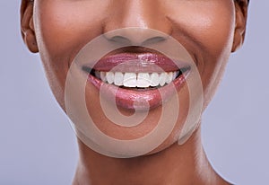 Lucious lips. a young womans mouth against a purple background.