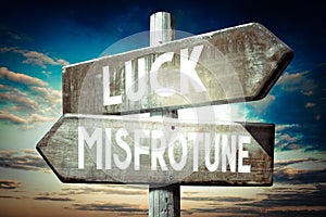 Luck, misfortune - wooden signpost, roadsign with two arrows