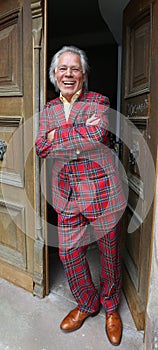 The lucky bridegroom dressed in a Steward Tartan-suit in front oft he old castle photo