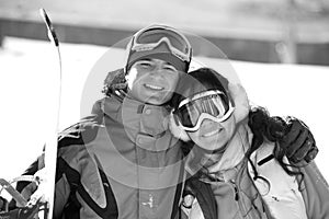 Lucky couple snowboarders in a mountain valley