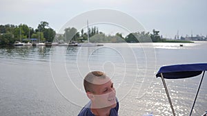 Lucky dad play with baby on loch, little boy in father`s strong hands in blue sky background,