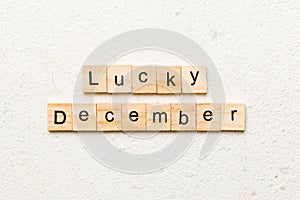 lucky december word written on wood block. lucky december text on table, concept