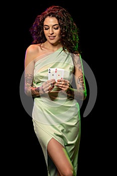 Lucky elegant young girl showing set of winning pair of aces