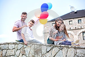 Lucky family sitting on the bridge side