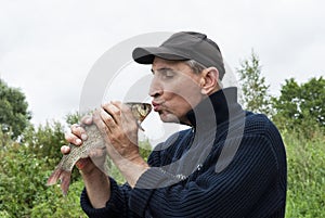 A lucky fisherman kiss a chub