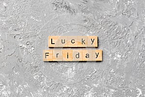 Lucky friday word written on wood block. lucky friday text on cement table for your desing, concept