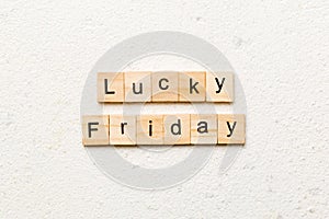 lucky friday word written on wood block. lucky friday text on cement table for your desing, concept