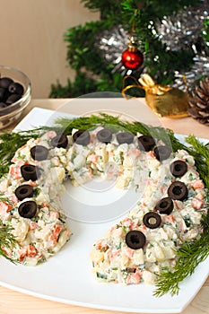 Lucky horseshoe-shaped russian salad for New Year