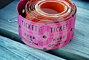 pink raffle tickets on wood photo