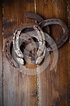 Lucky old  horseshoes laying at wooden floor